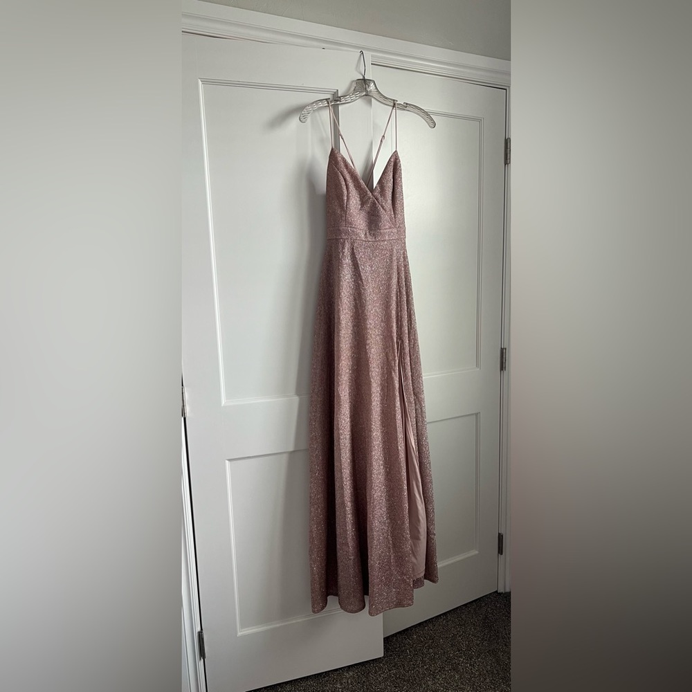 Pink glitter dress with adjustable shoulder straps and a leg slit at the bottom